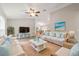 Bright and airy living room featuring comfortable seating and large TV at 28 Juniper Pass Dr, Ocala, FL 34480