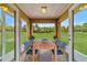 Enjoy dining al fresco in this screened lanai, overlooking a lush green backyard at 28 Juniper Pass Dr, Ocala, FL 34480
