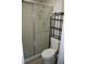 Bathroom with a shower, toilet, and a metal shelving unit at 3706 Ne 16Th Pl, Ocala, FL 34470