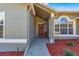 Front entry with red door and walkway at 3864 Se 59Th Pl, Ocala, FL 34480