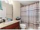 Clean bathroom with granite countertop and striped shower curtain at 4219 Ne 33Rd Ave, Ocala, FL 34479