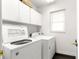 Laundry room with washer, dryer, and overhead cabinets at 4219 Ne 33Rd Ave, Ocala, FL 34479