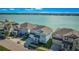 Two-story light blue house with lake view and street parking at 455 Blue Cypress Dr, Groveland, FL 34736