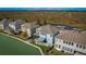 Back of two story light blue house with canal view and patio at 455 Blue Cypress Dr, Groveland, FL 34736