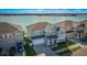 Two-story light blue house with lake view and boat dock at 455 Blue Cypress Dr, Groveland, FL 34736