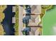 Aerial view of a house and backyard with a patio and fire pit, located on a canal at 455 Blue Cypress Dr, Groveland, FL 34736