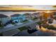 Houses on lakefront street with boat docks at sunset at 455 Blue Cypress Dr, Groveland, FL 34736