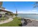 Lakefront backyard with firepit and patio furniture at 455 Blue Cypress Dr, Groveland, FL 34736