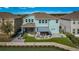 Two-story light blue house with covered patio and firepit at 455 Blue Cypress Dr, Groveland, FL 34736