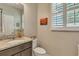 Small bathroom with granite countertop, toilet and updated vanity at 455 Blue Cypress Dr, Groveland, FL 34736