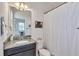 Clean bathroom with granite countertop, single sink vanity, and shower/tub at 455 Blue Cypress Dr, Groveland, FL 34736