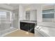 Spa-like bathroom with a large soaking tub, walk-in shower, and dual vanity at 455 Blue Cypress Dr, Groveland, FL 34736