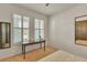 Guest bedroom with a desk, mirror, and window with shutters at 455 Blue Cypress Dr, Groveland, FL 34736