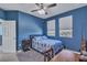 Blue bedroom with double bed, desk and view at 455 Blue Cypress Dr, Groveland, FL 34736