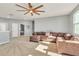 Large bonus room with sectional sofa and ceiling fan at 455 Blue Cypress Dr, Groveland, FL 34736