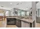 Modern kitchen with dark brown cabinets, granite countertops and stainless steel appliances at 455 Blue Cypress Dr, Groveland, FL 34736