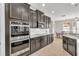 Modern kitchen with dark brown cabinets, granite countertops and stainless steel appliances at 455 Blue Cypress Dr, Groveland, FL 34736
