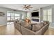 Relaxing living room boasts a fireplace and access to a screened porch at 455 Blue Cypress Dr, Groveland, FL 34736