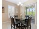 Casual dining area with glass table and access to the backyard at 10927 Se 168Th Loop, Summerfield, FL 34491