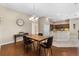 Bright dining room with hardwood floors and a wood dining table with kitchen view at 10927 Se 168Th Loop, Summerfield, FL 34491