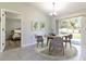 Dining area with round table, four chairs, and view of backyard from sliding doors at 17023 Sw 41St Avenue Rd, Ocala, FL 34473