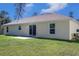 House back view, showcasing a sliding glass door, and a patio at 17023 Sw 41St Avenue Rd, Ocala, FL 34473