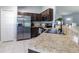 Modern kitchen featuring stainless steel appliances and dark brown cabinets at 17023 Sw 41St Avenue Rd, Ocala, FL 34473