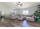 Spacious living room with L-shaped sofa, ottoman, and wood-look flooring at 17023 Sw 41St Avenue Rd, Ocala, FL 34473