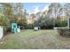 Large backyard with playset, shed, and wooded area at 20390 Sw 57Th St, Dunnellon, FL 34431