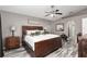 Main bedroom with king-size bed, nightstands, and ceiling fan at 20390 Sw 57Th St, Dunnellon, FL 34431