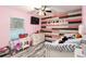 bedroom with pink walls, wood-like floors, and a daybed at 20390 Sw 57Th St, Dunnellon, FL 34431
