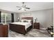 Large bedroom with king-size bed, and wood flooring at 20390 Sw 57Th St, Dunnellon, FL 34431