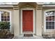 Red front door with arched entryway and sidelights at 20390 Sw 57Th St, Dunnellon, FL 34431