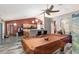 Game room features a pool table and an open concept view into the kitchen at 20390 Sw 57Th St, Dunnellon, FL 34431