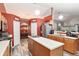 Open kitchen with island, stainless steel appliances, and wood cabinets at 20390 Sw 57Th St, Dunnellon, FL 34431