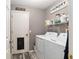 Laundry room with washer, dryer, and storage shelving at 20390 Sw 57Th St, Dunnellon, FL 34431