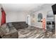 Living area with grey sectional sofa and wood-look flooring at 20390 Sw 57Th St, Dunnellon, FL 34431