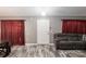 Living room with grey sectional sofa and wood-look flooring at 20390 Sw 57Th St, Dunnellon, FL 34431