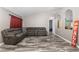 Spacious living room with grey sectional sofa and wood-look flooring at 20390 Sw 57Th St, Dunnellon, FL 34431