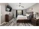Main bedroom with large bed, dresser, and window with natural light at 20390 Sw 57Th St, Dunnellon, FL 34431