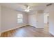 Bright bedroom with wood-look floors, ceiling fan, and ample closet space at 21150 Sw Marine Blvd, Dunnellon, FL 34431