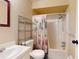 Bathroom with shower/tub combo and a metal shelving unit at 21174 Sw Peach Blossom St, Dunnellon, FL 34431