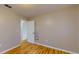 Bedroom with hardwood floors and mirror, near bathroom at 21174 Sw Peach Blossom St, Dunnellon, FL 34431