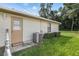 Home exterior with AC unit and side door entry at 21174 Sw Peach Blossom St, Dunnellon, FL 34431
