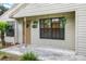 House front view with porch and hanging plants at 21174 Sw Peach Blossom St, Dunnellon, FL 34431
