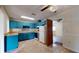 Teal kitchen with access to garage and ample counter space at 21174 Sw Peach Blossom St, Dunnellon, FL 34431