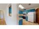 Teal kitchen with pass-through to living area at 21174 Sw Peach Blossom St, Dunnellon, FL 34431