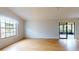 Spacious living room with laminate flooring and sliding doors to a screened porch at 21174 Sw Peach Blossom St, Dunnellon, FL 34431