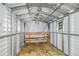Interior of a metal storage shed with wooden shelving at 21174 Sw Peach Blossom St, Dunnellon, FL 34431