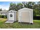 Two storage sheds in the backyard, one metal and one vinyl at 21174 Sw Peach Blossom St, Dunnellon, FL 34431